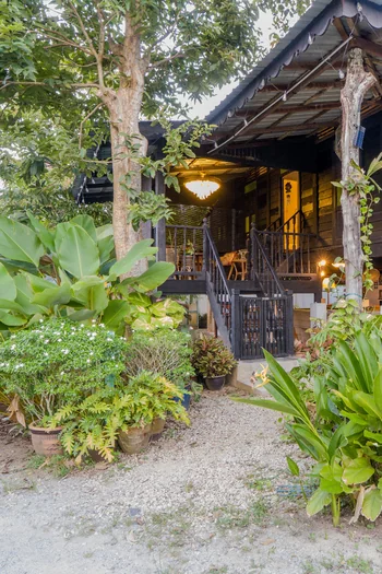 Rumah Teduh Langkawi – Garden Exterior Traditional Malay wooden house surrounded by tropical greenery at Rumah Teduh Langkawi.