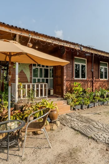 Rumah Teduh Langkawi – Wooden House & Garden Traditional wooden house with a shaded veranda and tropical garden at Rumah Teduh Langkawi.