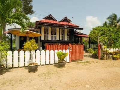 Traditional Malay house veranda at Rumah Teduh Langkawi with rattan chairs and bamboo blinds